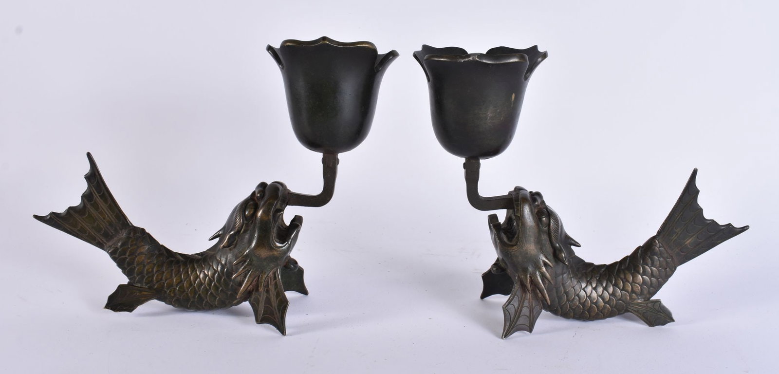 A RARE PAIR OF 18TH/19TH CENTURY JAPANESE EDO PERIOD BRONZE CANDLESTICKS formed as dragon fish. 18 c: A RARE PAIR OF 18TH/19TH CENTURY JAPANESE EDO PERIOD BRONZE CANDLESTICKS formed as dragon fish. 18 cm x 18 cm.