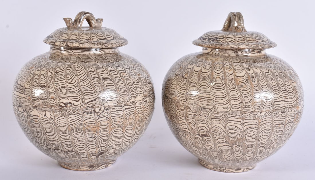 AN UNUSUAL PAIR OF CHINESE MARBLEISED POTTERY JARS AND COVERS. 16 cm x 12 cm: AN UNUSUAL PAIR OF CHINESE MARBLEISED POTTERY JARS AND COVERS. 16 cm x 12 cm