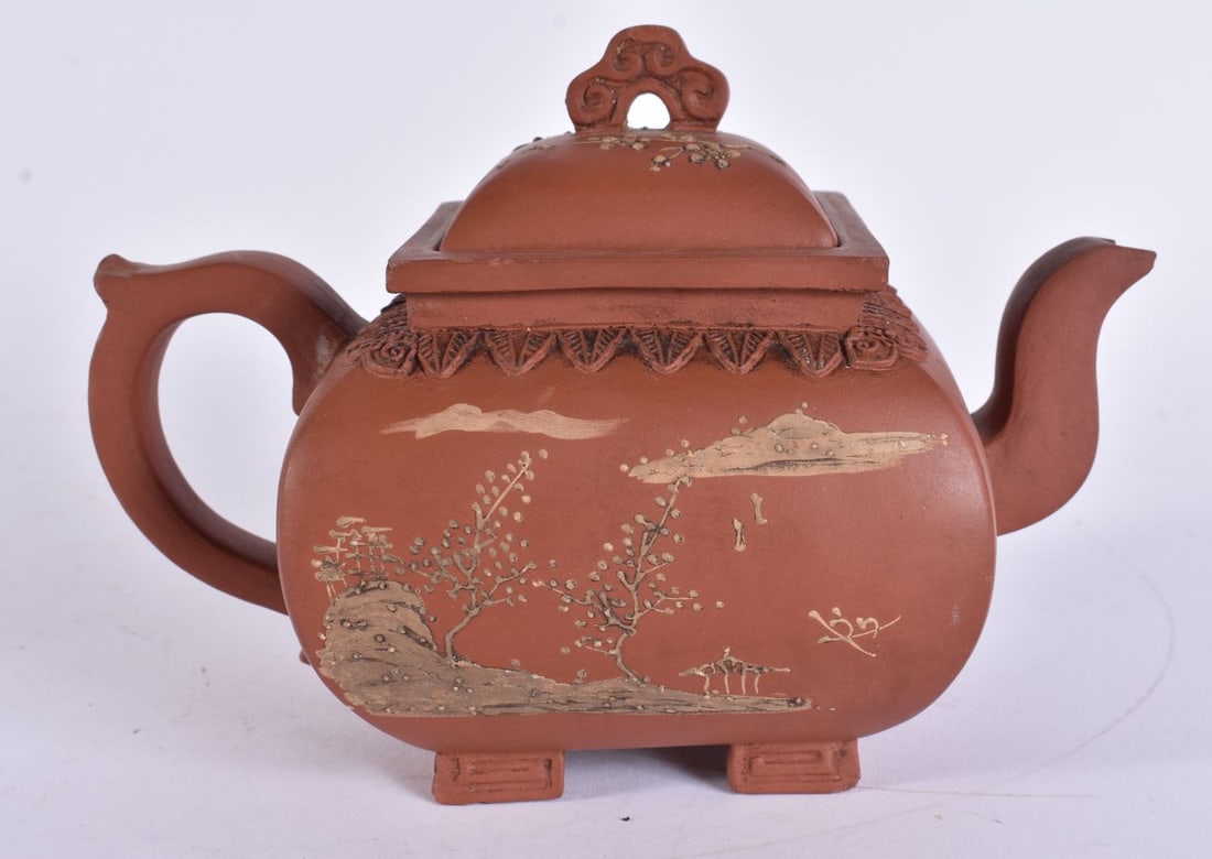 AN EARLY 20TH CENTURY CHINESE YIXING POTTERY TEAPOT AND COVER Late Qing, decorated with relief lands (1 of 7)