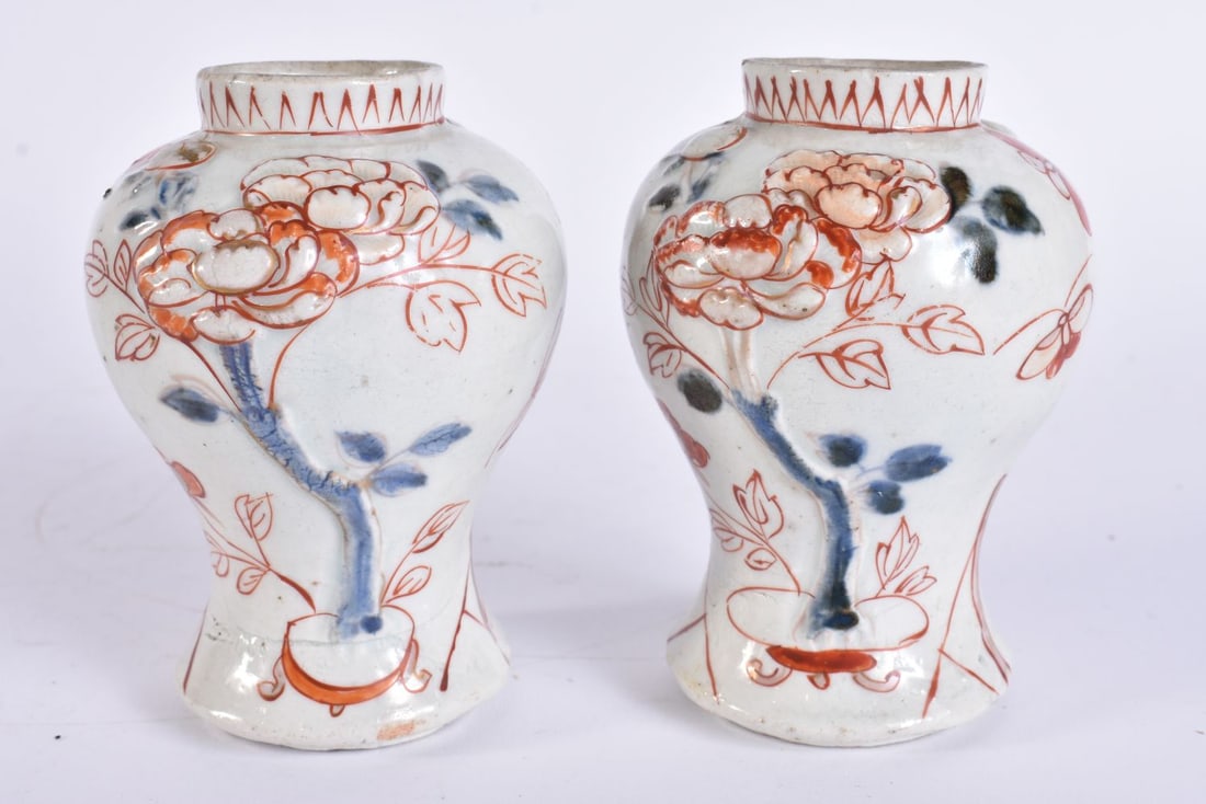 A PAIR OF 17TH/18TH CENTURY JAPANESE GENROKU PERIOD IMARI VASES decorated in relief with flowers. 11 (1 of 5)