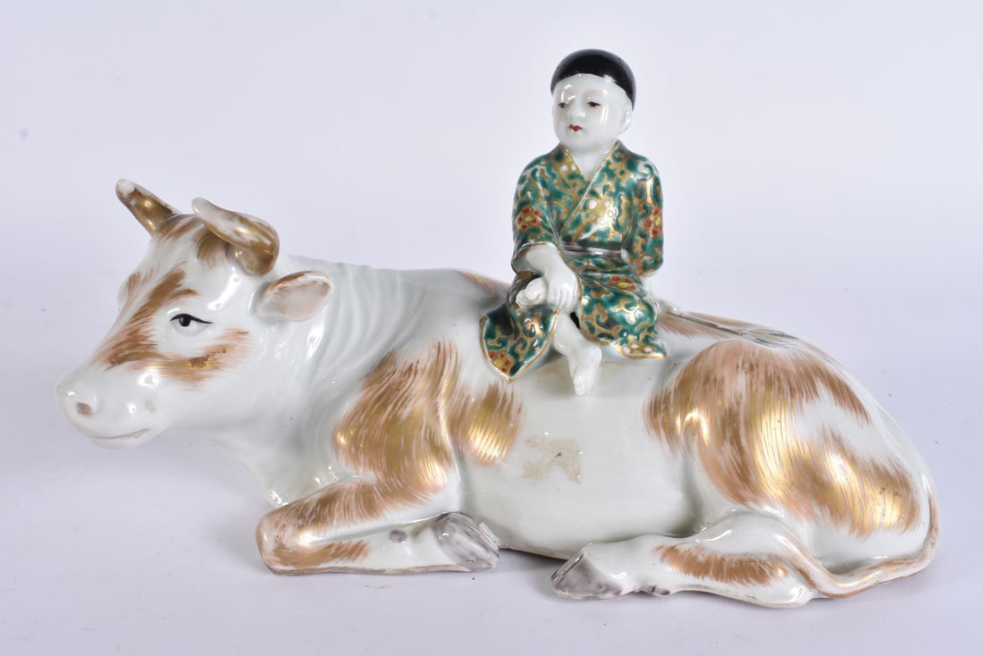 A 19TH CENTURY JAPANESE MEIJI PERIOD AO KUTANI PORCELAIN FIGURE modelled as a boy upon a cow. 21 cm (1 of 4)