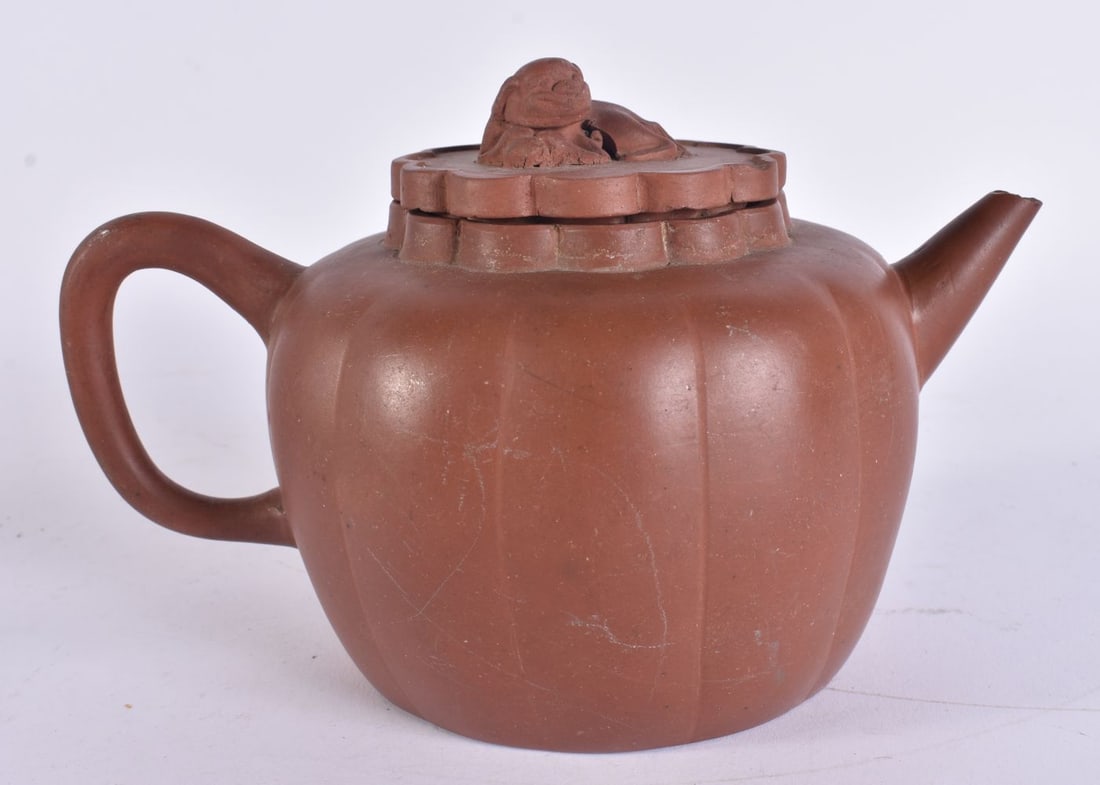A 19TH CENTURY CHINESE YIXING POTTERY TEAPOT AND COVER Late Qing. 18 cm wide.: A 19TH CENTURY CHINESE YIXING POTTERY TEAPOT AND COVER Late Qing. 18 cm wide.