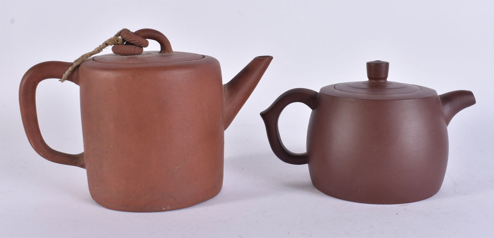 TWO CHINESE YIXING POTTERY TEAPOTS AND COVERS. Largest 15 cm wide. (2) (1 of 9)