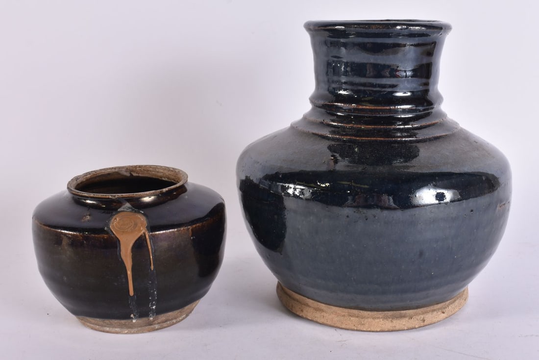 A CHINESE QING DYNASTY BLACK GLAZED POTTERY VASE together with a smaller jar. Largest 21 cm x 14 cm. (1 of 4)