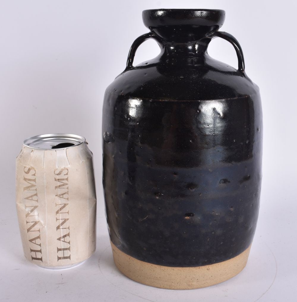 A CHINESE QING DYNASTY TWIN HANDLED BROWN GLAZED POTTERY VASE. 24 cm x 12 cm.: A CHINESE QING DYNASTY TWIN HANDLED BROWN GLAZED POTTERY VASE. 24 cm x 12 cm.