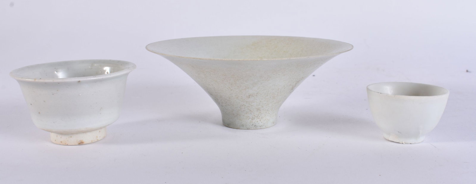 A CHINESE SUNG DYNASTY FLARED PORCELAIN BOWL together with two shipwreck teabowls. Largest 12.5 cm w (1 of 4)