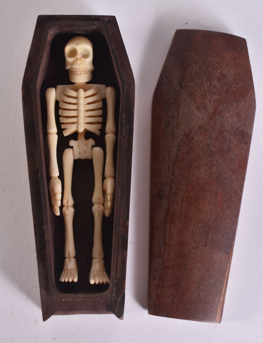 A JAPANESE MEMENTO MORI BONE SKELETON IN COFFIN. 12 cm wide. (1 of 3)
