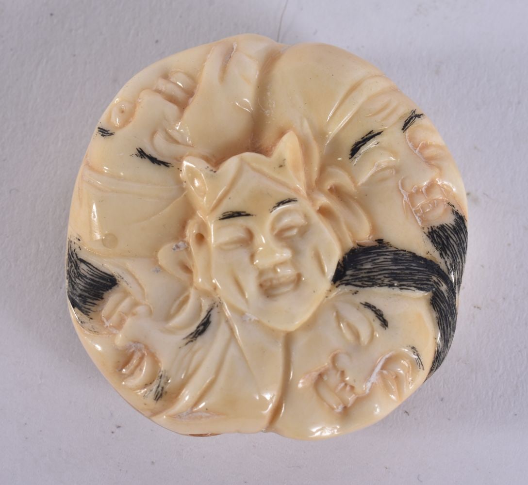 A JAPANESE BONE FACES NETSUKE. 4 cm wide. (1 of 3)