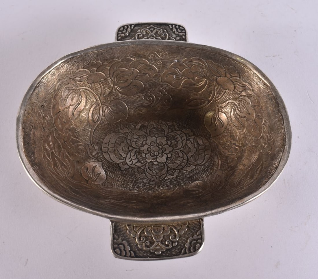 A CHINESE WHITE METAL EAR CUP. 13 cm x 12 cm. (1 of 3)