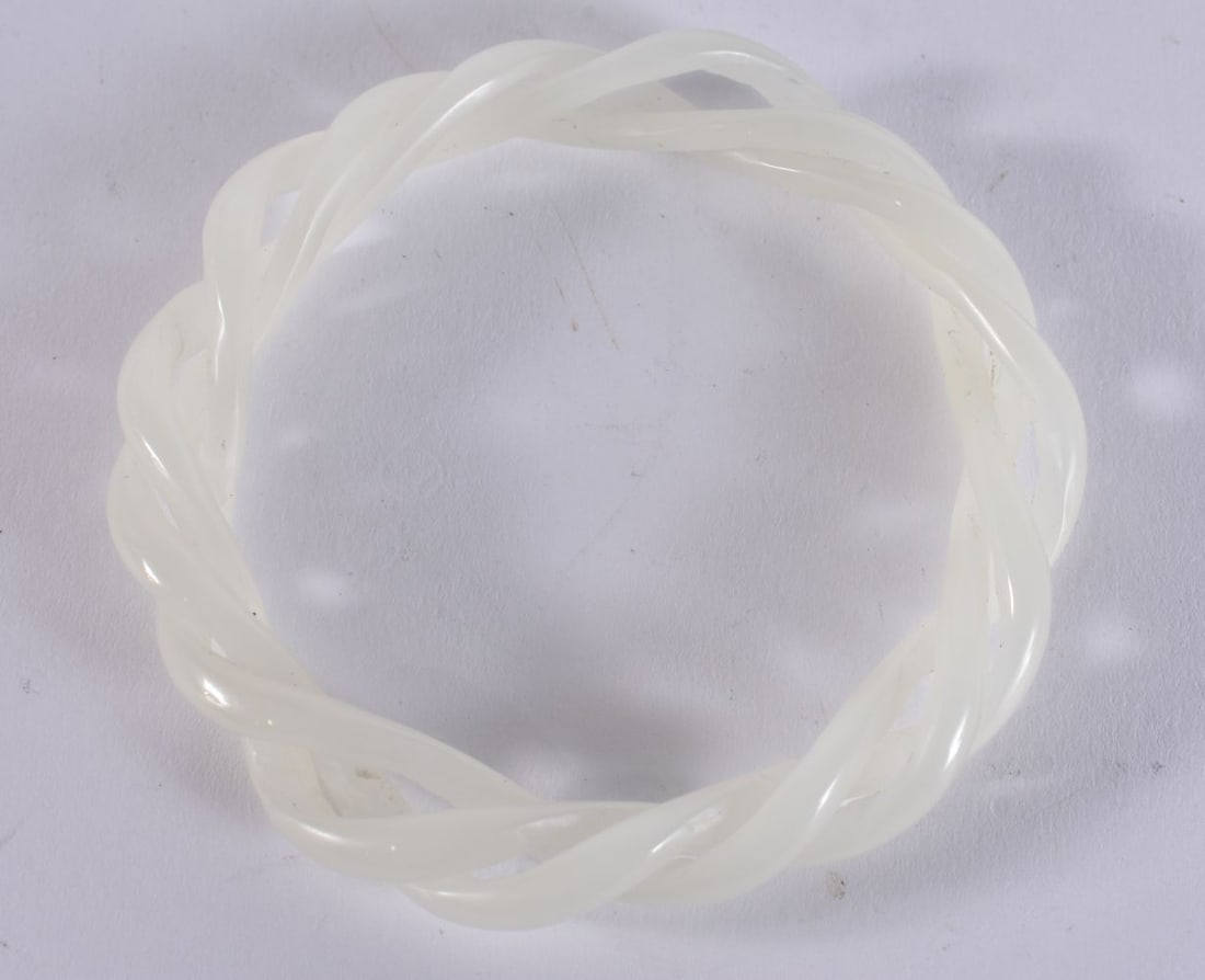 A CHINESE RETICULATED WHITE JADE BANGLE. 7.25 cm wide. (1 of 2)