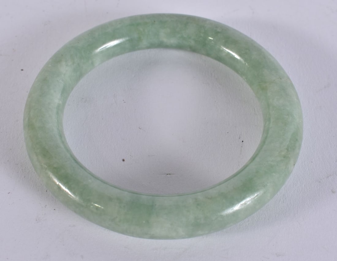 A CHINESE JADE BANGLE. 8 cm wide. (1 of 2)