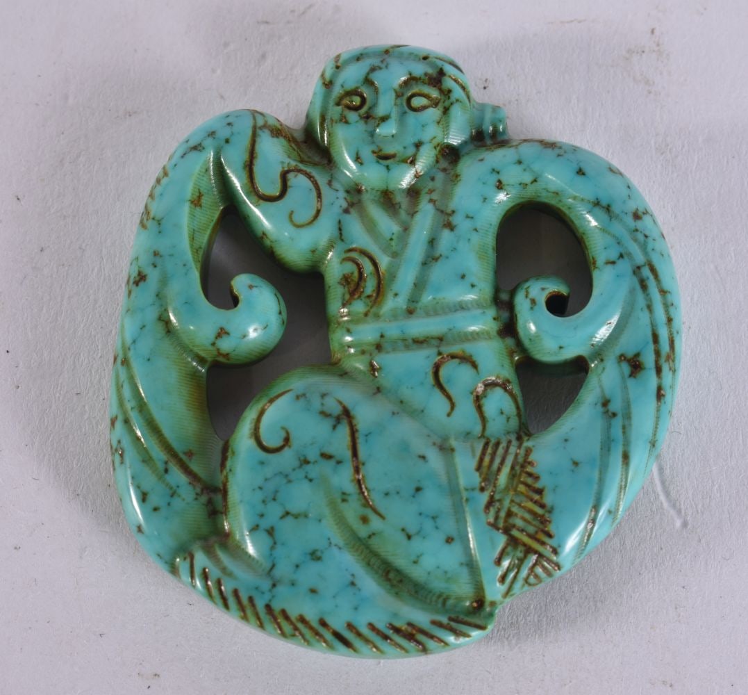 A CHINESE CARVED TURQUOISE AMULET. 4.5 cm x 4 cm.: A CHINESE CARVED TURQUOISE AMULET. 4.5 cm x 4 cm.