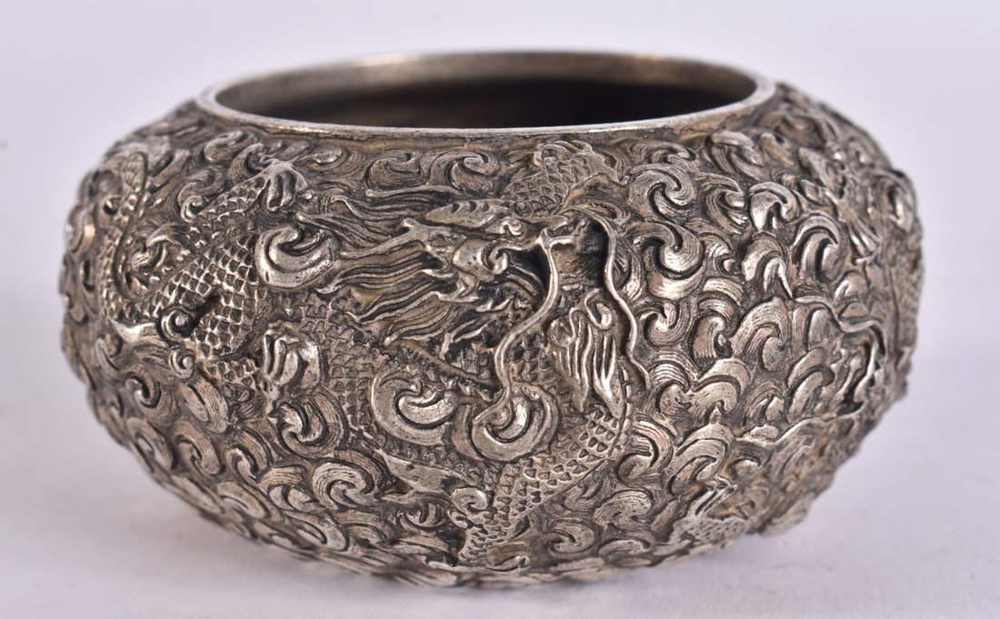 A CHINESE WHITE METAL DRAGON BOWL. 8.5 cm wide.: A CHINESE WHITE METAL DRAGON BOWL. 8.5 cm wide.