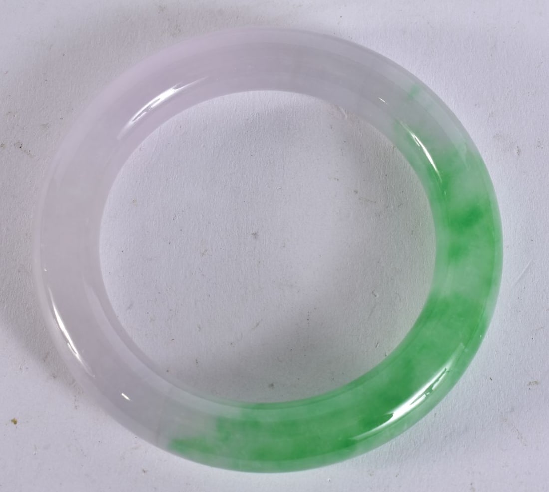 A CHINESE JADE BANGLE. 8.5 cm wide. (1 of 3)