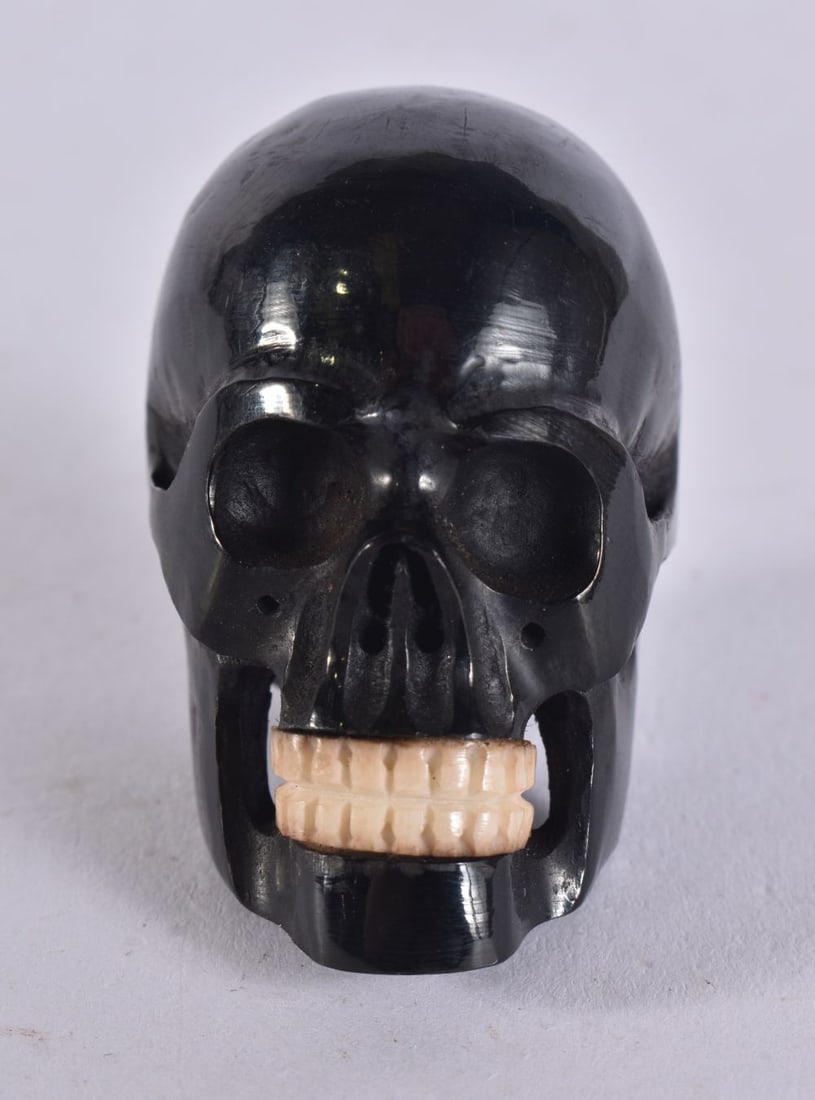 A JAPANESE CARVED WOOD AND BONE SKULL NETSUKE. 4 cm x 3.5 cm. (1 of 4)