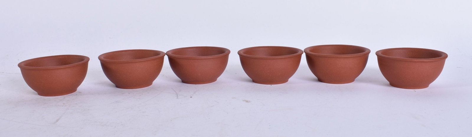 A SET OF SIX CHINESE YIXING POTTERY TEABOWLS. 5.75 cm wide. (6) (1 of 3)