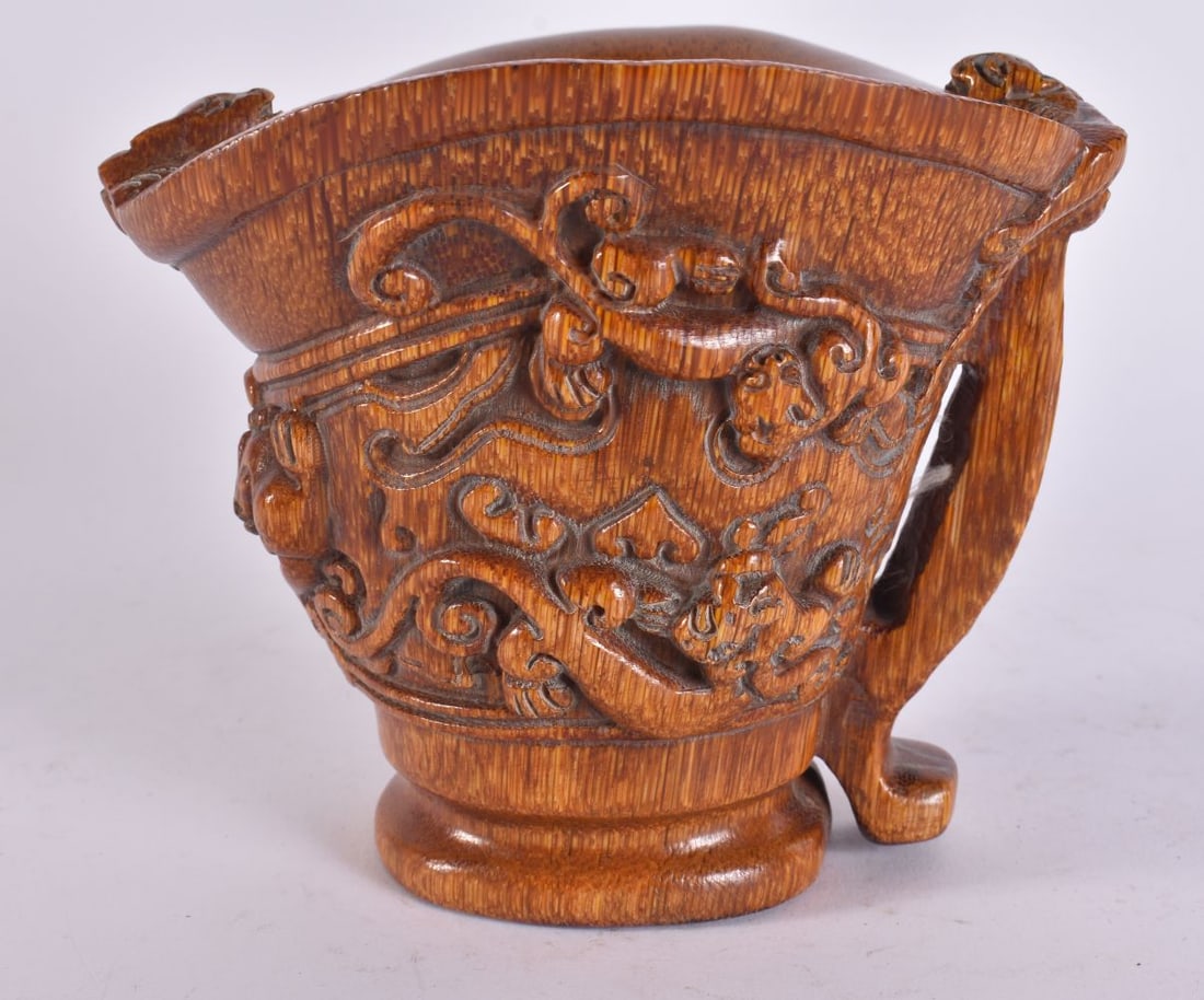 A CHINESE CARVED BUFFALO HORN TYPE LIBATION CUP. 13 cm x 13 cm.: A CHINESE CARVED BUFFALO HORN TYPE LIBATION CUP. 13 cm x 13 cm.