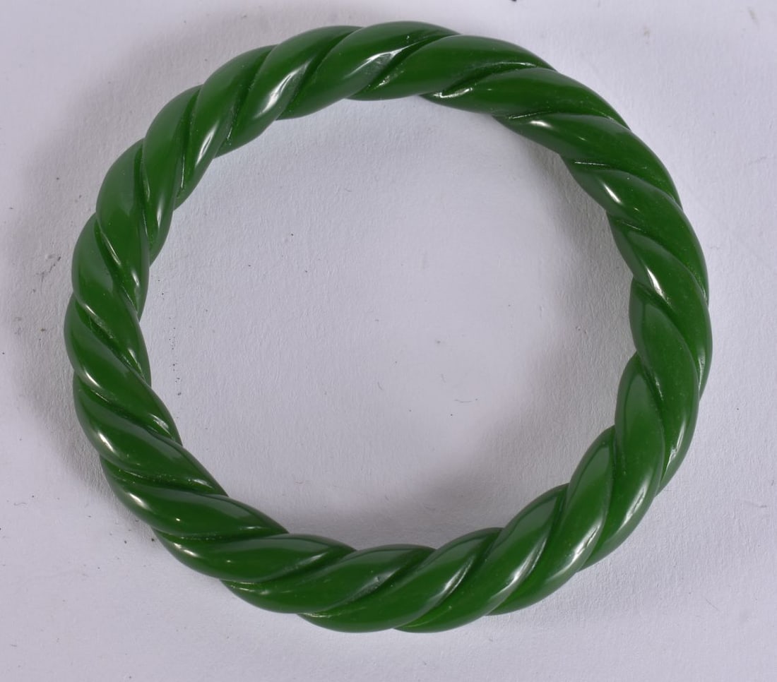 A CHINESE JADE TWIST BANGLE. 7.5 cm wide. (1 of 3)