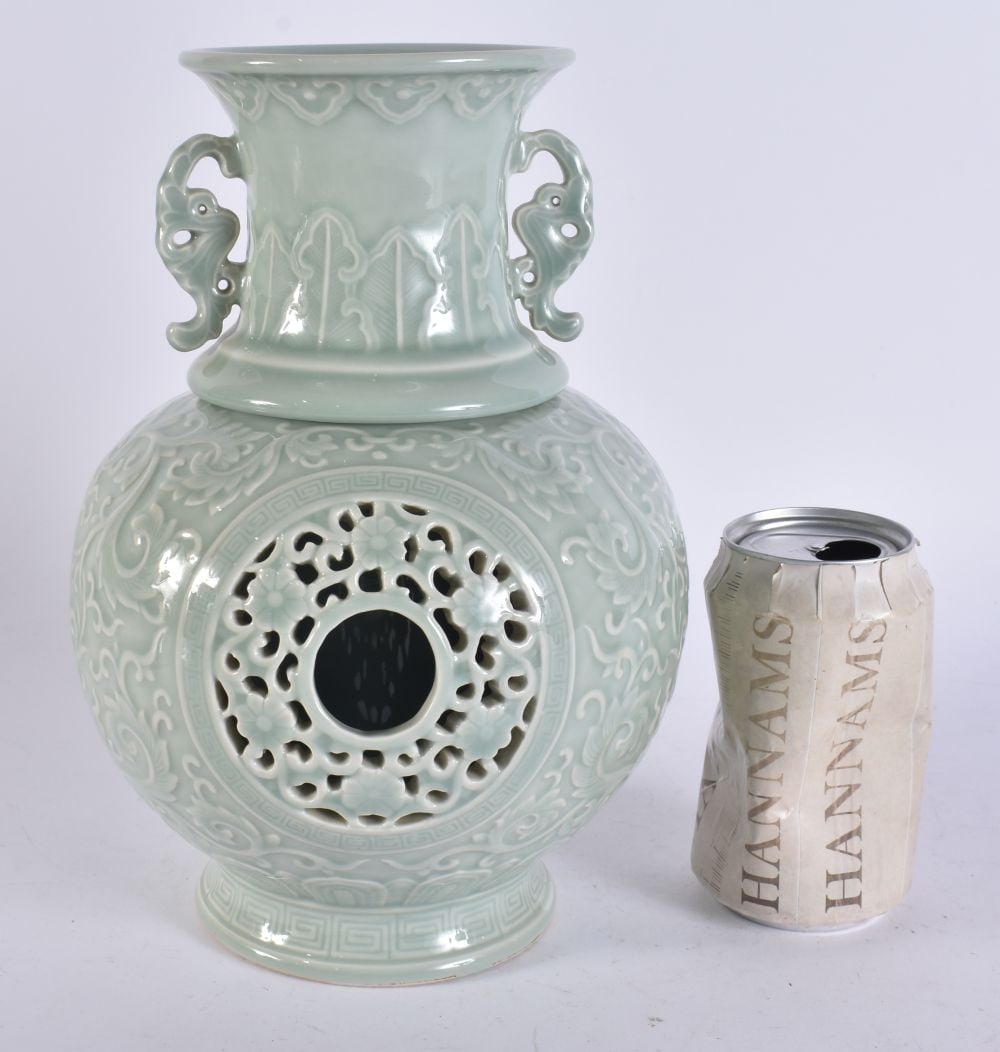 A CHINESE TWIN HANDLED CELADON REVOLVING RETICULATED VASE. 25.5 cm high. (1 of 6)