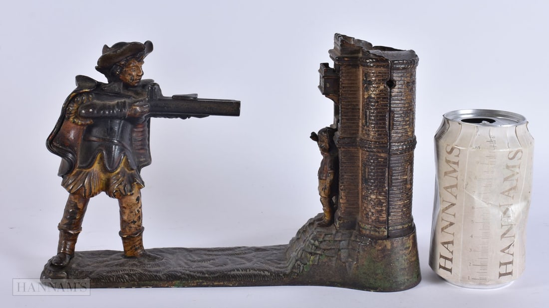 AN EARLY VICTORIAN CAST IRON MONEY BOX modelled as a male holding a rifle opposing a child. 25 cm x: AN EARLY VICTORIAN CAST IRON MONEY BOX modelled as a male holding a rifle opposing a child. 25 cm x 16 cm.