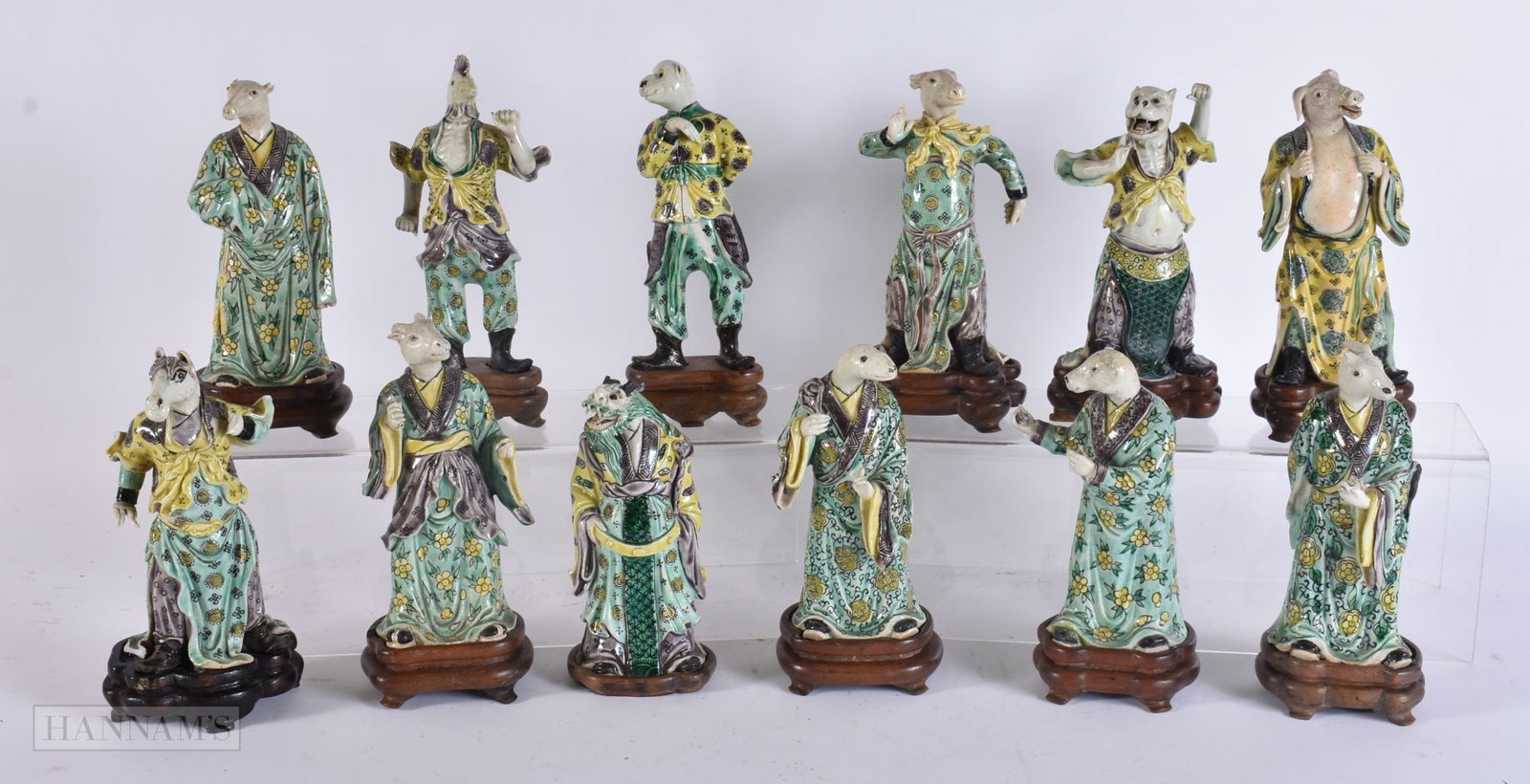 A VERY RARE SET OF TWELVE CHINESE QING DYNASTY FAMILLE VERTE ZODIAC FIGURES modelled upon fitted har: A VERY RARE SET OF TWELVE CHINESE QING DYNASTY FAMILLE VERTE ZODIAC FIGURES modelled upon fitted hardwood bases. 17.5 cm high. (12)