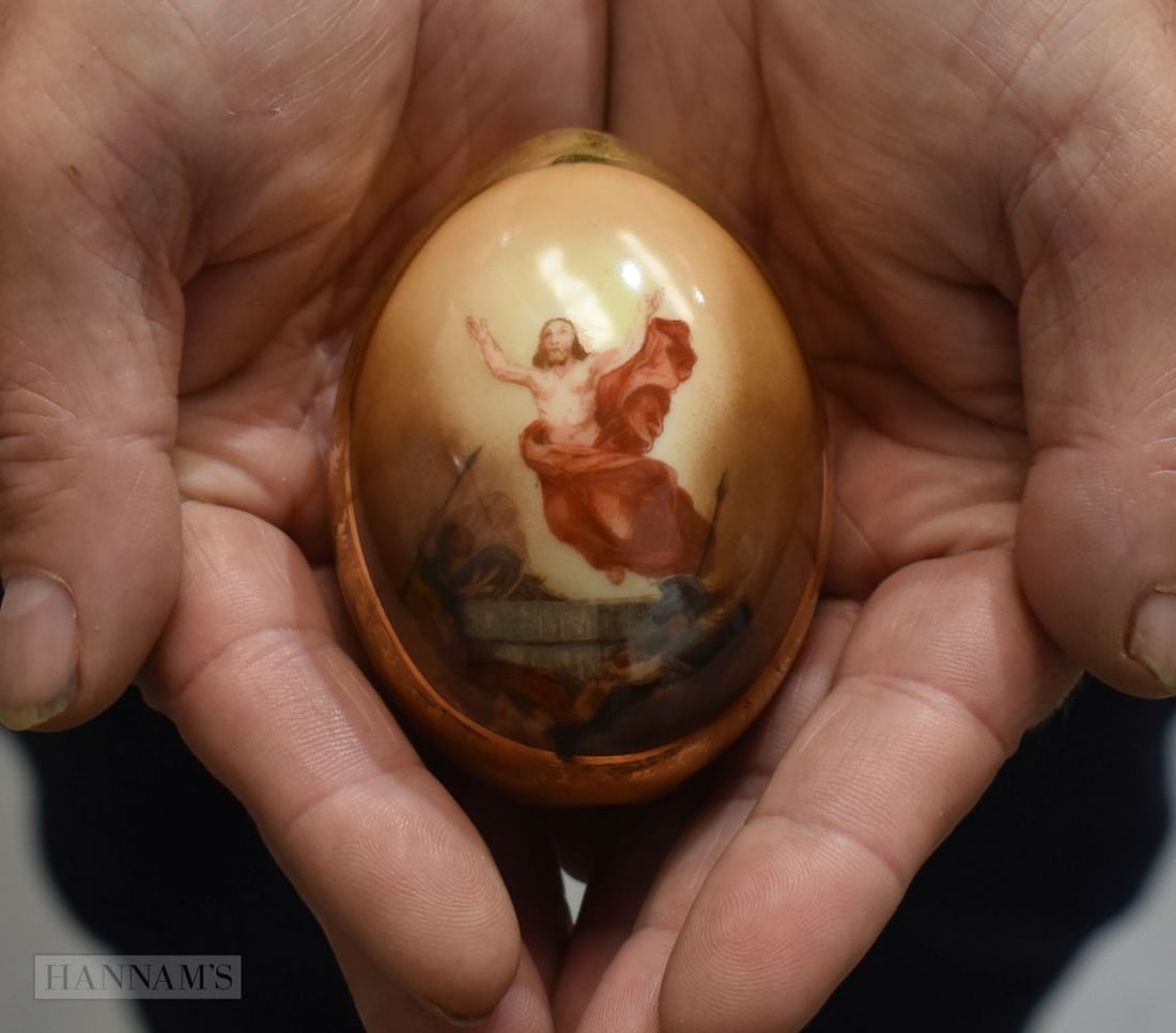 A FINE RUSSIAN PORCELAIN PAINTED EASTER EGG decorated with Christ emerging over fallen soldiers. 8.5 (1 of 4)