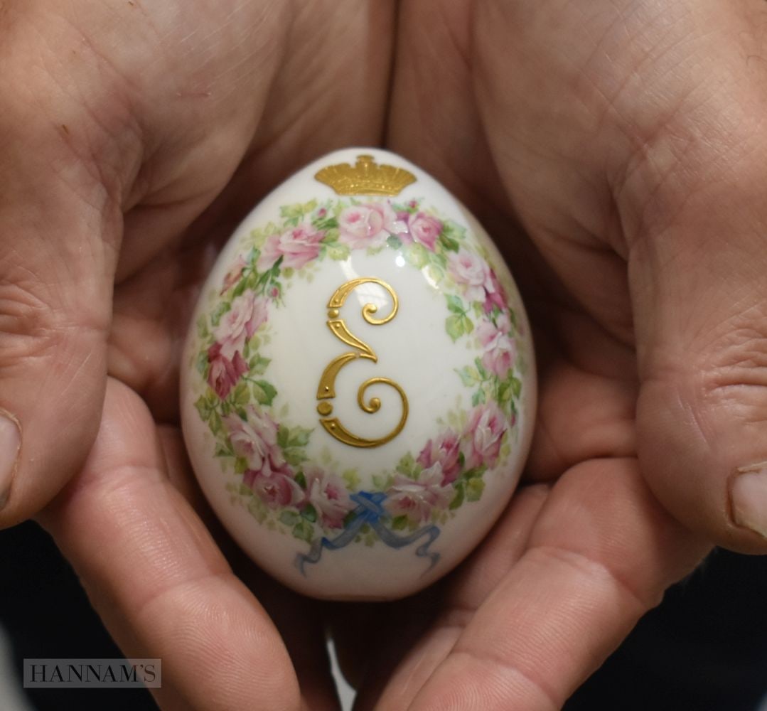 A RUSSIAN PORCELAIN PAINTED EASTER EGG decorated with an Imperial emblem encased within flowers. 7.7 (1 of 4)