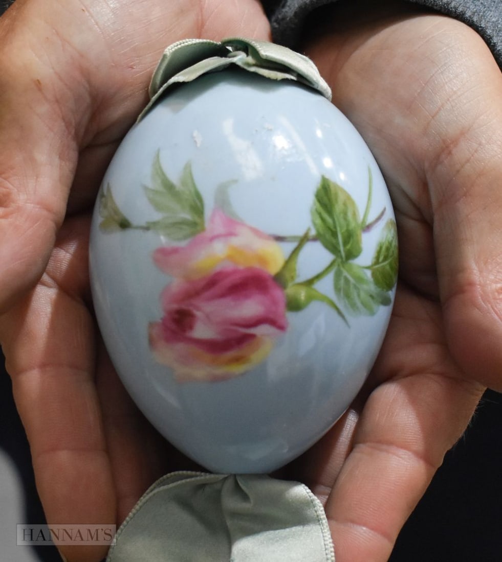 A RUSSIAN PORCELAIN PAINTED EASTER EGG decorated with flowers on a pale blue ground. 11 cm x 6 cm. (1 of 4)