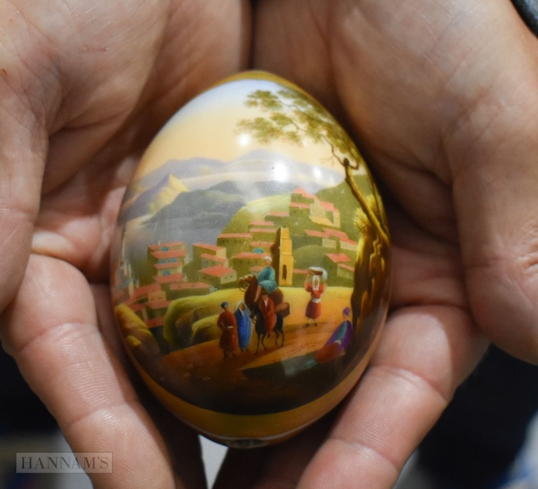 A RUSSIAN IMPERIAL PORCELAIN PAINTED EASTER EGG decorated with figures within a landscape. 9.5 cm x: A RUSSIAN IMPERIAL PORCELAIN PAINTED EASTER EGG decorated with figures within a landscape. 9.5 cm x 6.5 cm.