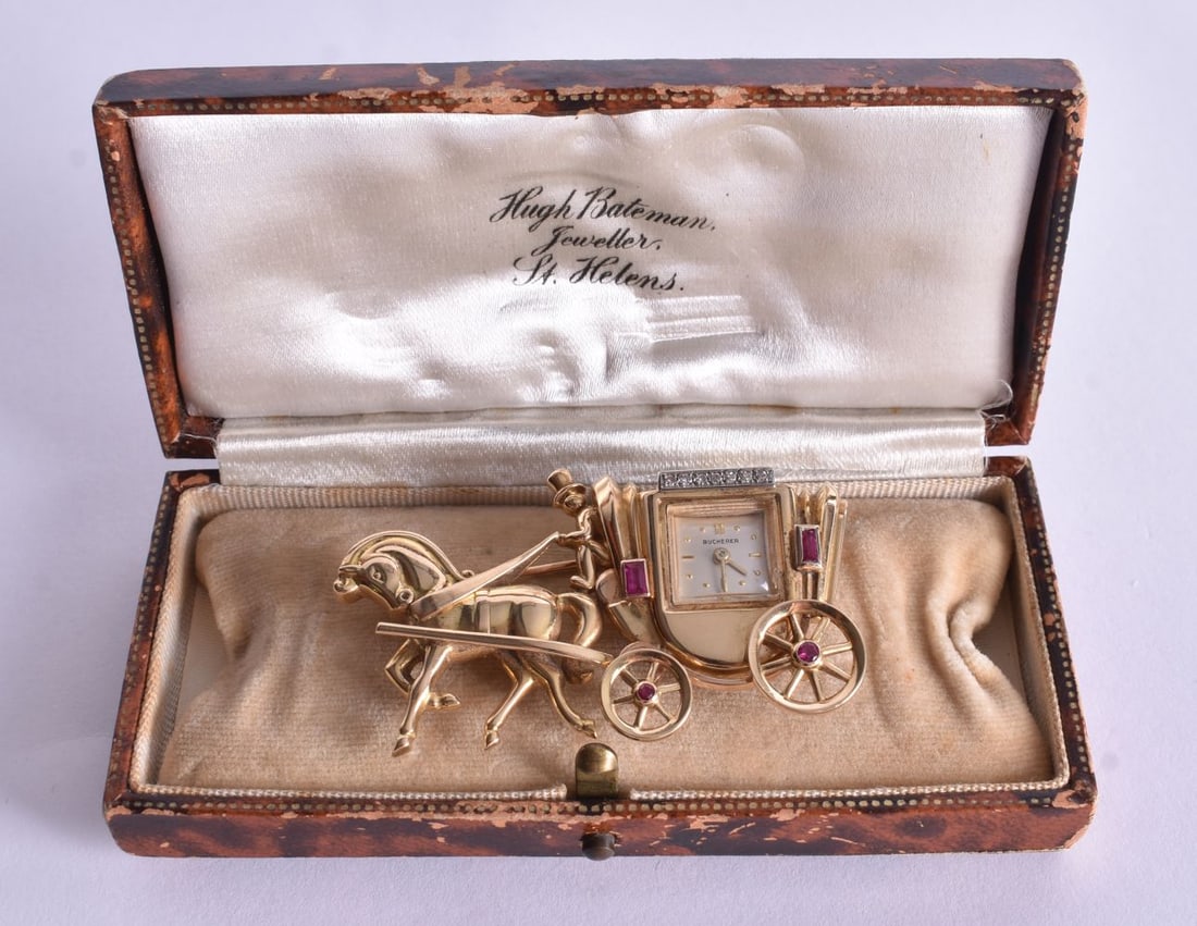 A Buchere Diamond and Ruby Set 18 Carat Gold Horse and Carriage Watch Brooch with an associated box+: A Buchere Diamond and Ruby Set 18 Carat Gold Horse and Carriage Watch Brooch with an associated box++. Stamped 18K 750. Not working 3.2cm x 5.4cm, weight 24.8g