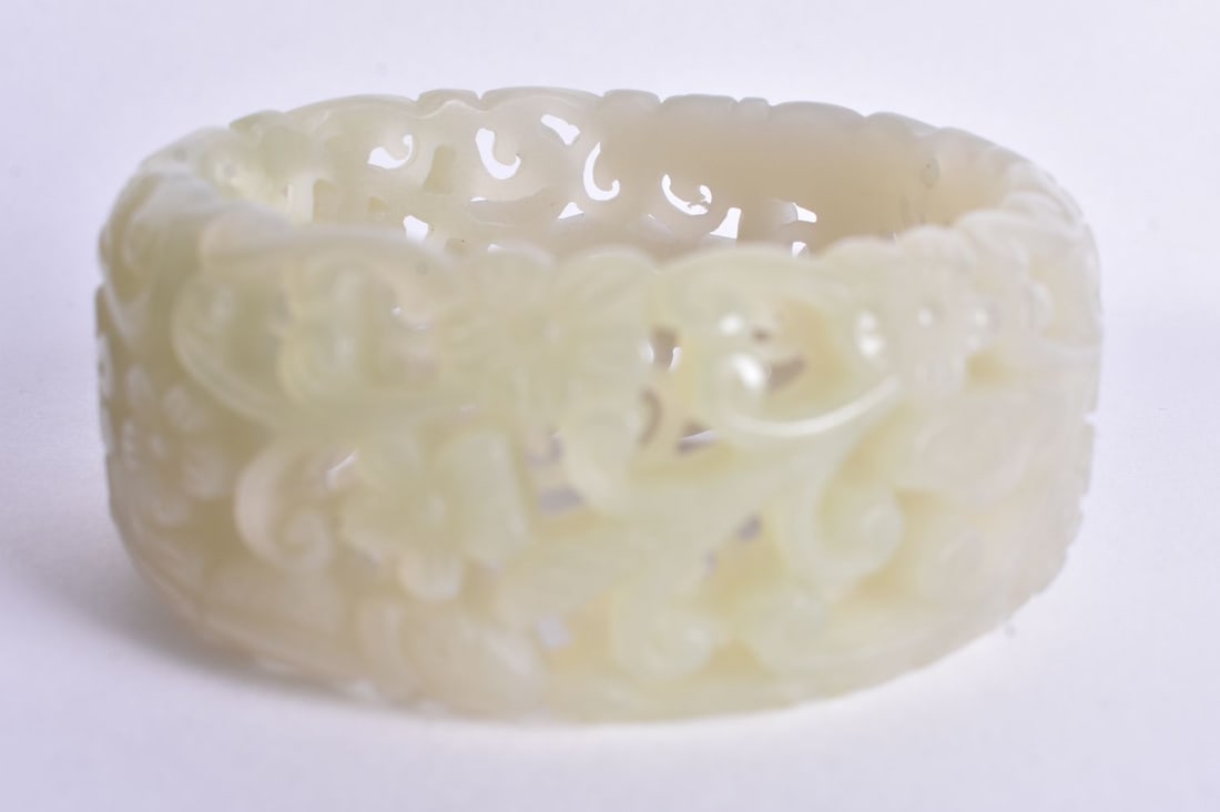 A Pierced Celadon Jade Bangle. Internal diameter 6cm, weight 84.8g (1 of 3)
