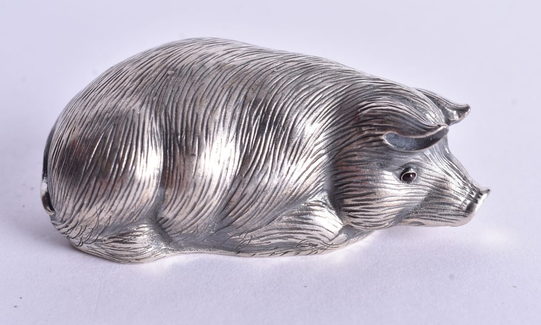 A Continental Silver Model of a Recumbent Pig with chased decoration. Stamped 84. 2.4cm x 6.1cm x 3: A Continental Silver Model of a Recumbent Pig with chased decoration. Stamped 84. 2.4cm x 6.1cm x 3.2cm, weight 30.9g