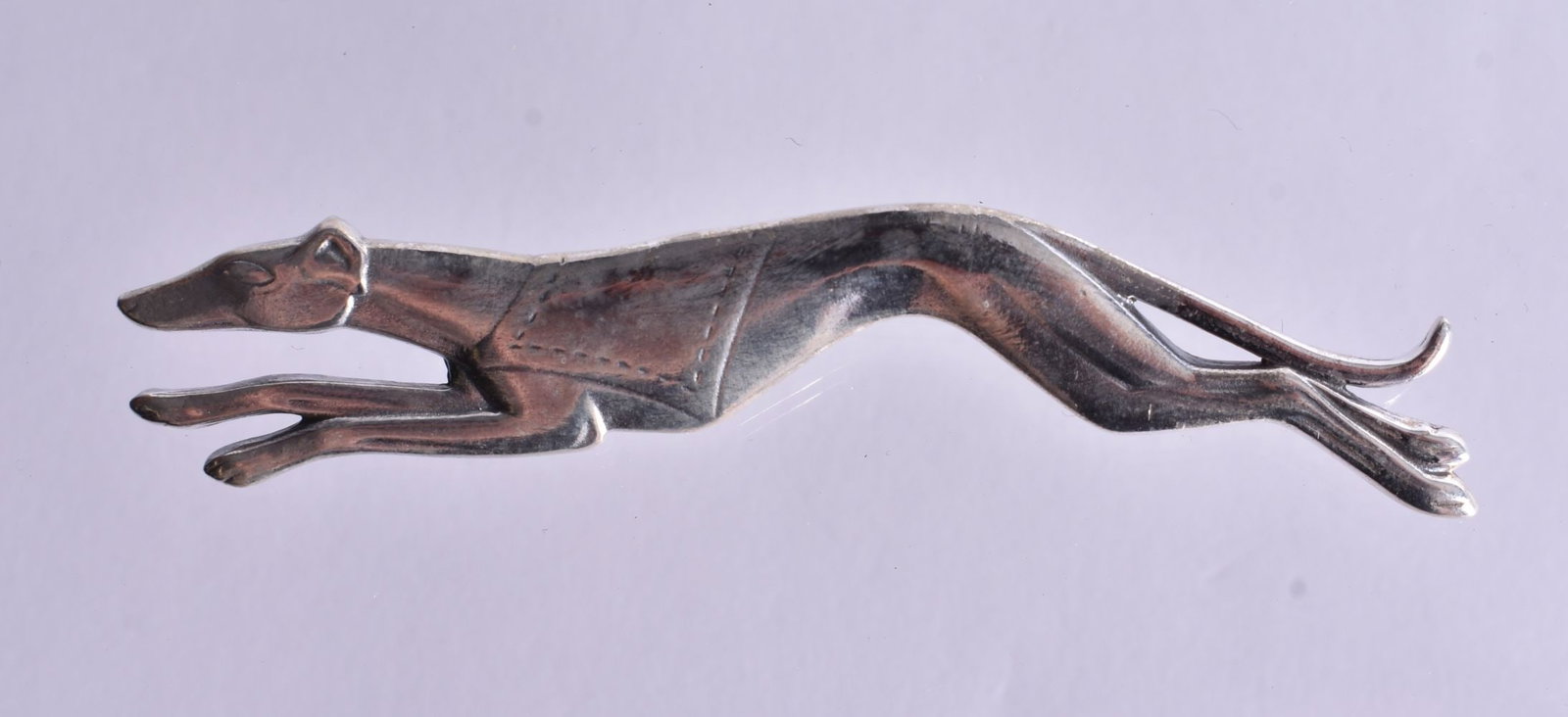 A Silver Running Greyhound Brooch. Stamped Sterling. 3.9cm x 1.4cm, weight 8.4g (1 of 2)
