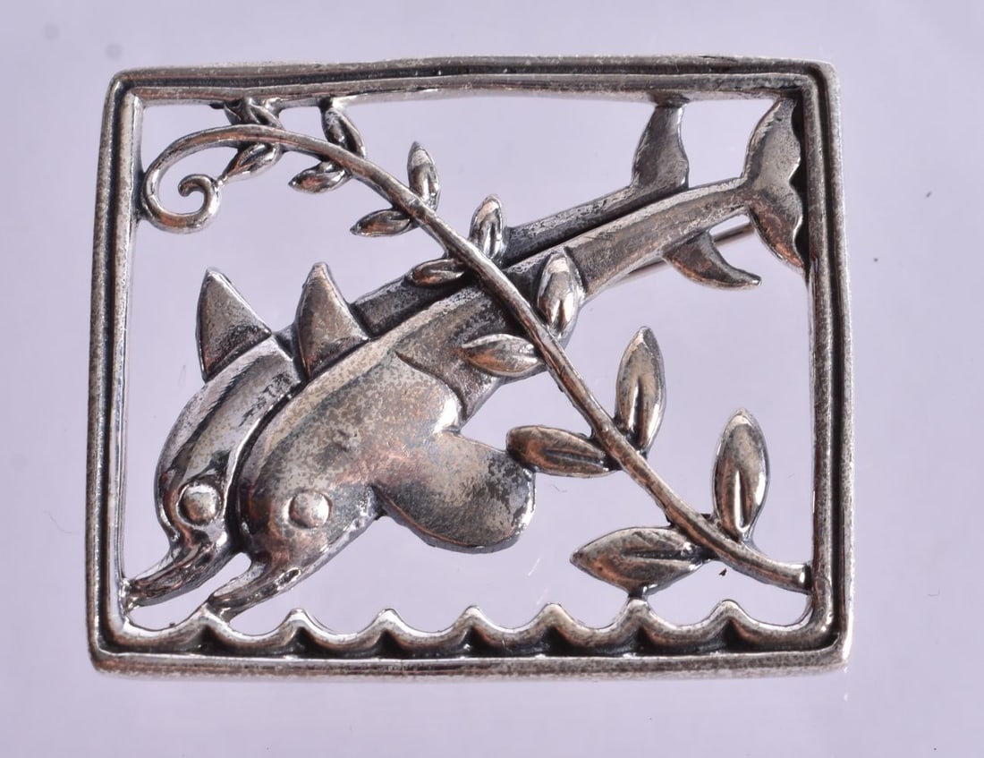 A Silver Dolphin Brooch. Stamped Sterling. 2.8cm x 3.3cm, weight 9.5g (1 of 2)