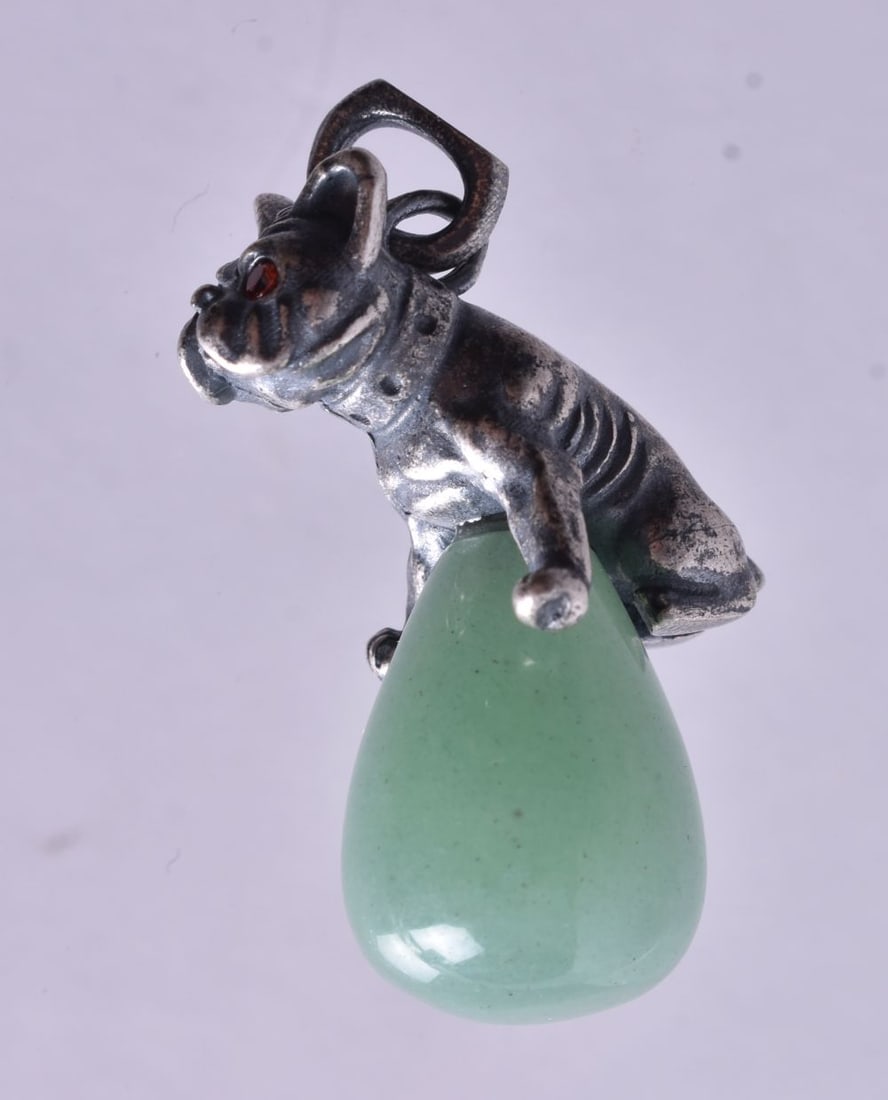 A Jade Pendant with a Continental Silver Dog Mount. Stamped 84. 2.4cm x 2.2cm x 1.3cm, weight 10.2: A Jade Pendant with a Continental Silver Dog Mount. Stamped 84. 2.4cm x 2.2cm x 1.3cm, weight 10.2g