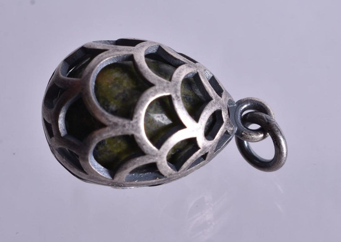 A Hardstone Pendant with Pierced Silver casing and mount. Bail Stamped 84. 2.2cm x 1.4cm, weight 7: A Hardstone Pendant with Pierced Silver casing and mount. Bail Stamped 84. 2.2cm x 1.4cm, weight 7.2g