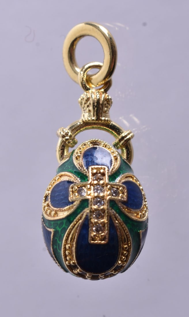 A Continental Silver Gilt and Green Enamel Egg Pendant. Rubbed Marks on Bail. 3cm drop, weight 6.6: A Continental Silver Gilt and Green Enamel Egg Pendant. Rubbed Marks on Bail. 3cm drop, weight 6.6g