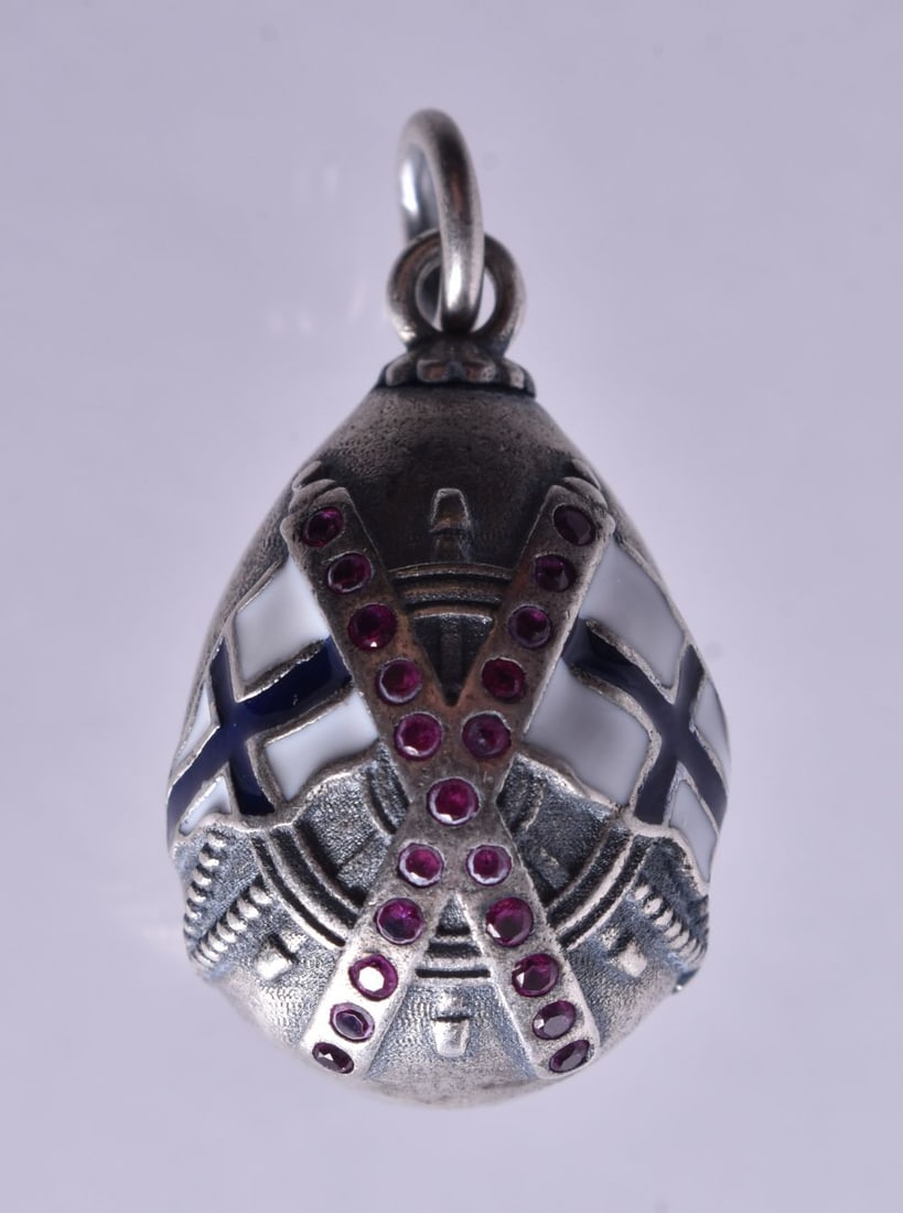A Continental Silver Egg Pendant with Enamel Flag decoration. Stamped 84. 2.8cm x 1.5cm, weight 8.: A Continental Silver Egg Pendant with Enamel Flag decoration. Stamped 84. 2.8cm x 1.5cm, weight 8.6g