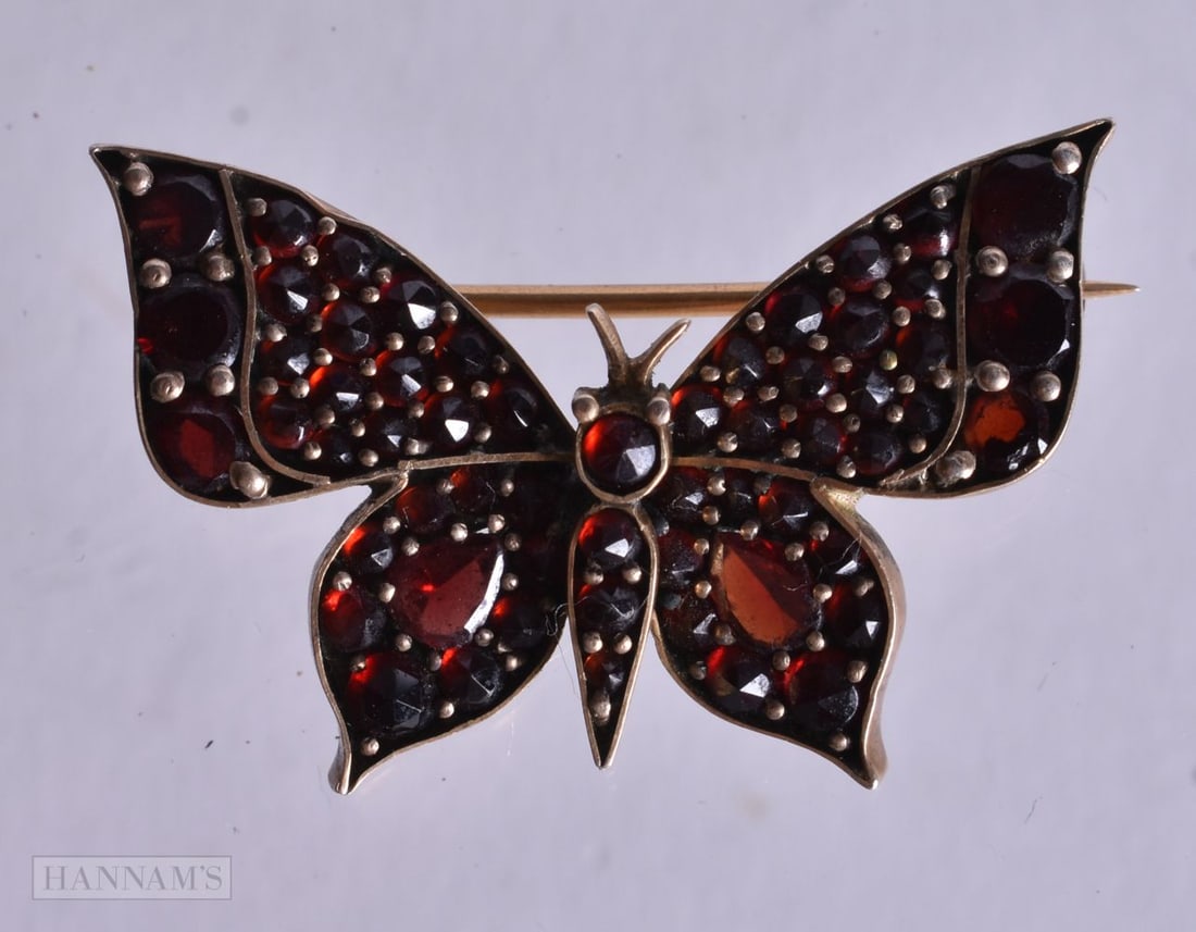 A Garnet Encrusted Butterfly Brooch. 2.1cm x 3cm, weight 4g (1 of 2)