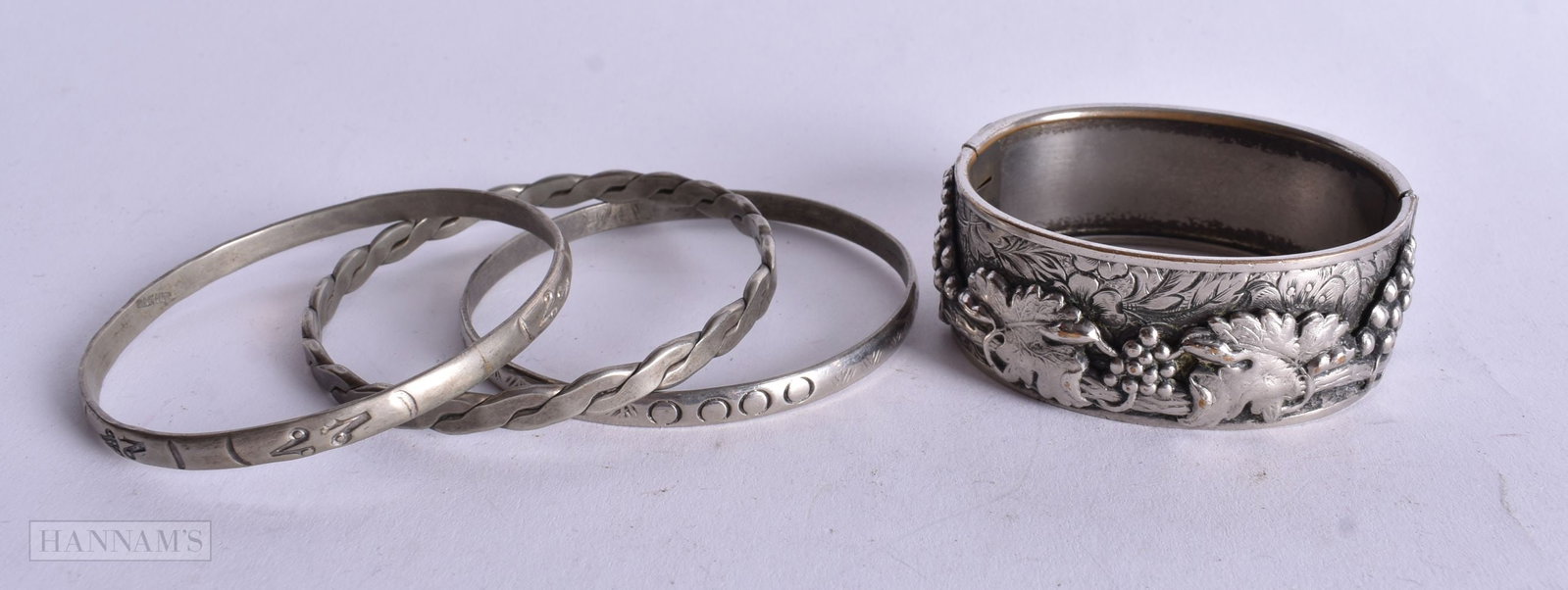 Four Mexican White Metal Bangles, 3 stamped Sterling, 1 stamped Mexico. Largest 6.6cm internal diam: Four Mexican White Metal Bangles, 3 stamped Sterling, 1 stamped Mexico. Largest 6.6cm internal diameter, total weight 98g (4)