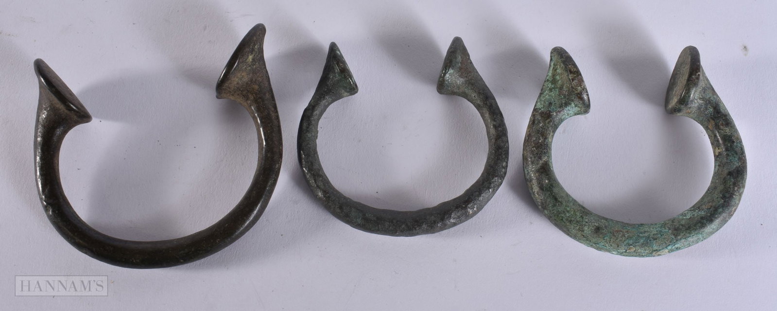 THREE ANTIQUITY BRONZE MANILLAS. 7 cm wide. (3): THREE ANTIQUITY BRONZE MANILLAS. 7 cm wide. (3)