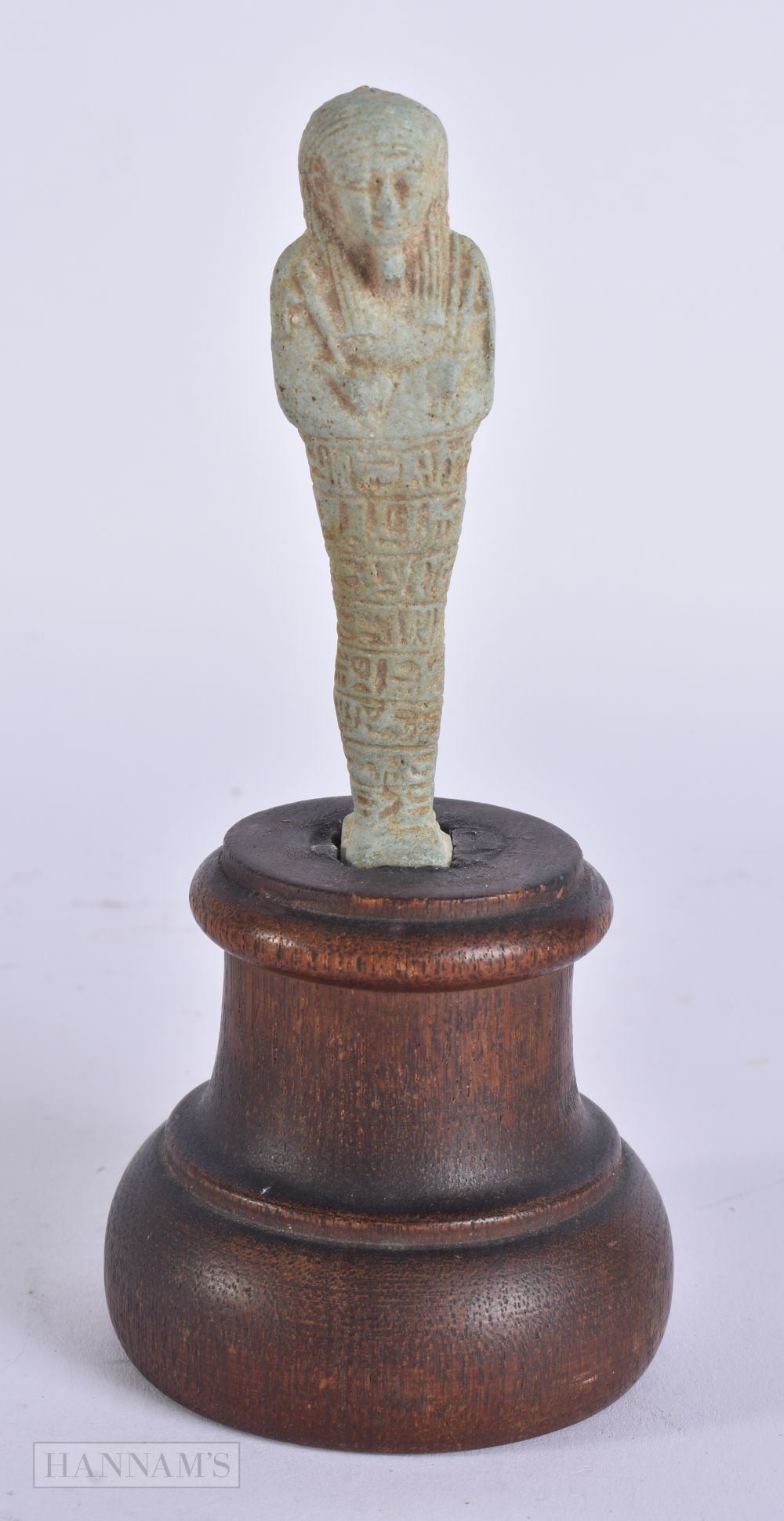 AN EGYPTIAN FAIENCE USHABTI. Figure 9.25 cm high. (1 of 5)
