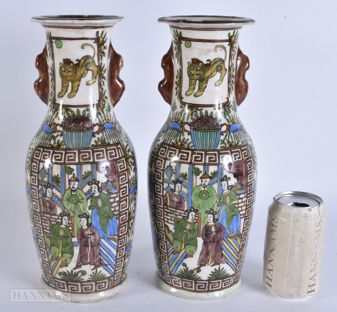 A PAIR OF 19TH CENTURY PERSIAN QAJAR POTTERY VASES painted with figures. 31.5 cm high.: A PAIR OF 19TH CENTURY PERSIAN QAJAR POTTERY VASES painted with figures. 31.5 cm high.