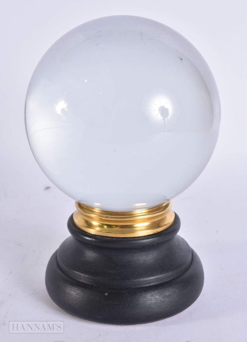 A CRYSTAL BALL ON STAND. 18 cm high. (1 of 3)