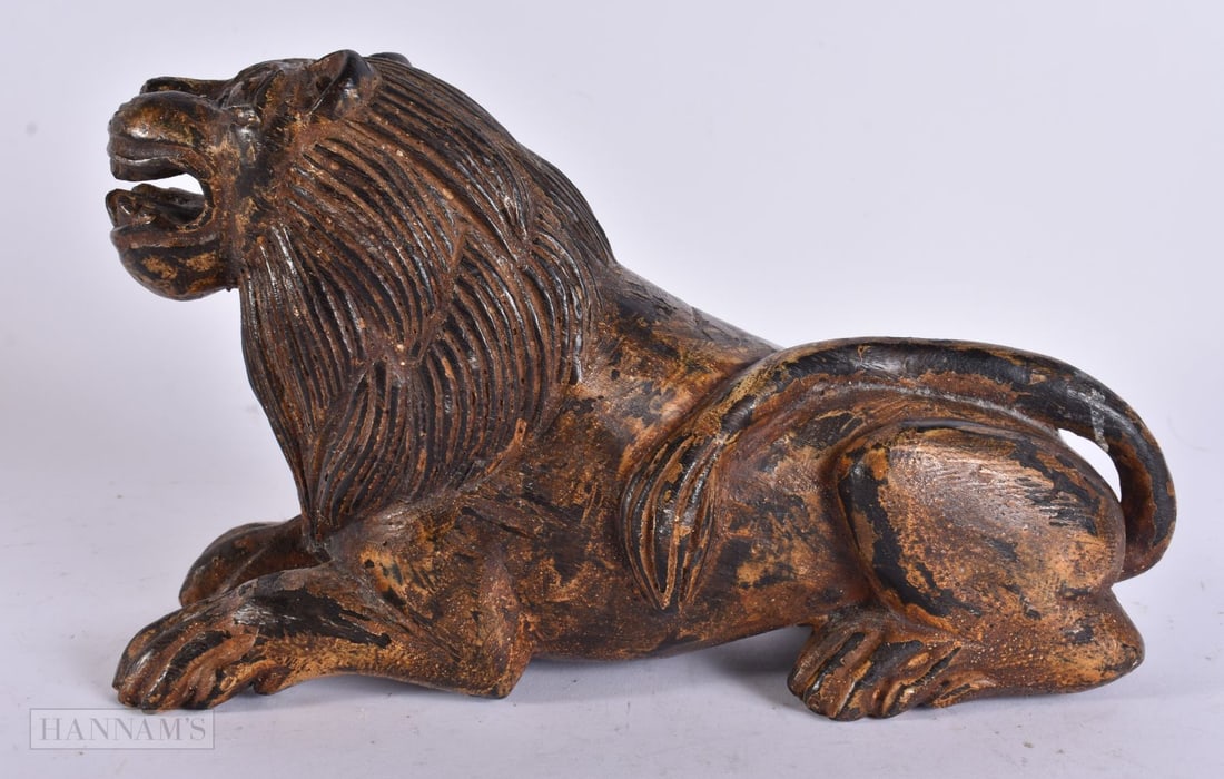A 19TH CENTURY CARVED AND GILDED WOOD FIGURE OF A LION. 25 cm x 15 cm. (1 of 5)
