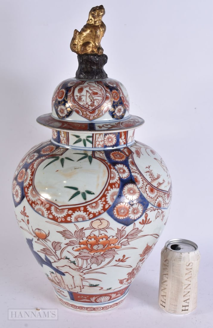 A LARGE 17TH/18TH CENTURY JAPANESE GENROKU PERIOD IMARI VASE AND COVER painted with landscapes. 48 c: A LARGE 17TH/18TH CENTURY JAPANESE GENROKU PERIOD IMARI VASE AND COVER painted with landscapes. 48 cm x 20 cm.