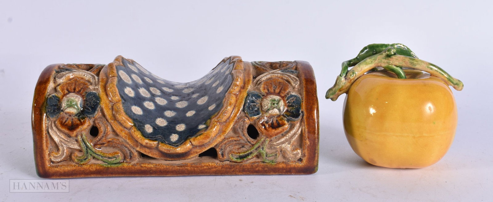 A CHINESE POTTERY PILLOW and a porcelain fruit. Largest 16 cm wide. (2) (1 of 4)