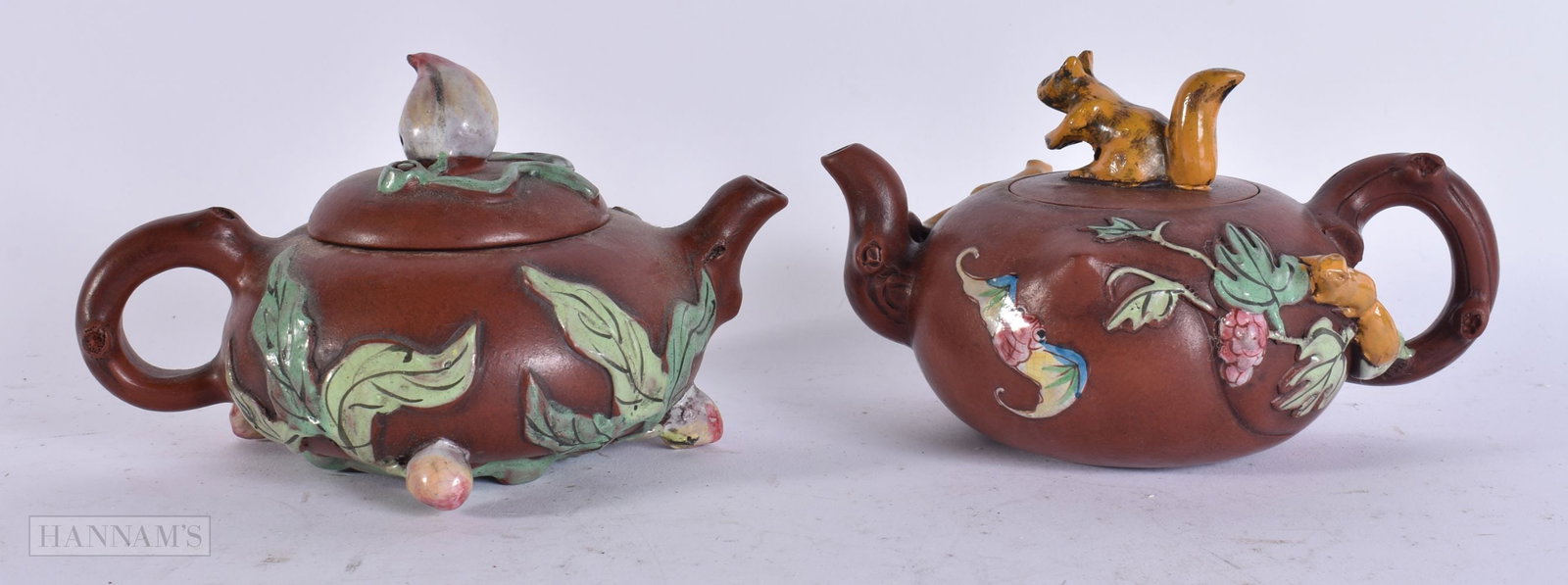 TWO CHINESE YIXING POTTERY TEAPOTS. 13 cm wide. (2): TWO CHINESE YIXING POTTERY TEAPOTS. 13 cm wide. (2)