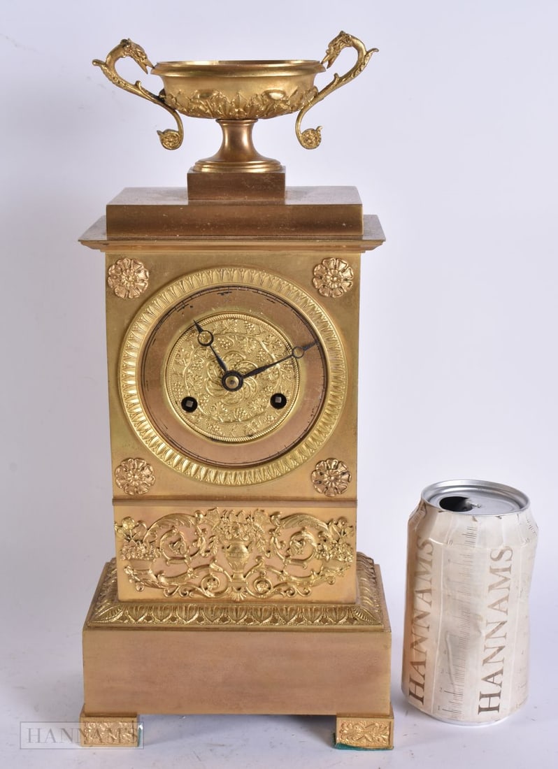A 19TH CENTURY FRENCH GILT BRONZE MANTEL CLOCK overlaid with swags and urns. 34 cm x 12 cm.: A 19TH CENTURY FRENCH GILT BRONZE MANTEL CLOCK overlaid with swags and urns. 34 cm x 12 cm.