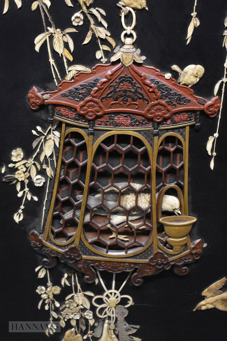A FINE AND LARGE 19TH CENTURY JAPANESE MEIJI PERIOD LACQUERED PANEL beautifully formed with a bird w: A FINE AND LARGE 19TH CENTURY JAPANESE MEIJI PERIOD LACQUERED PANEL beautifully formed with a bird within a cage. 128 cm x 76 cm.